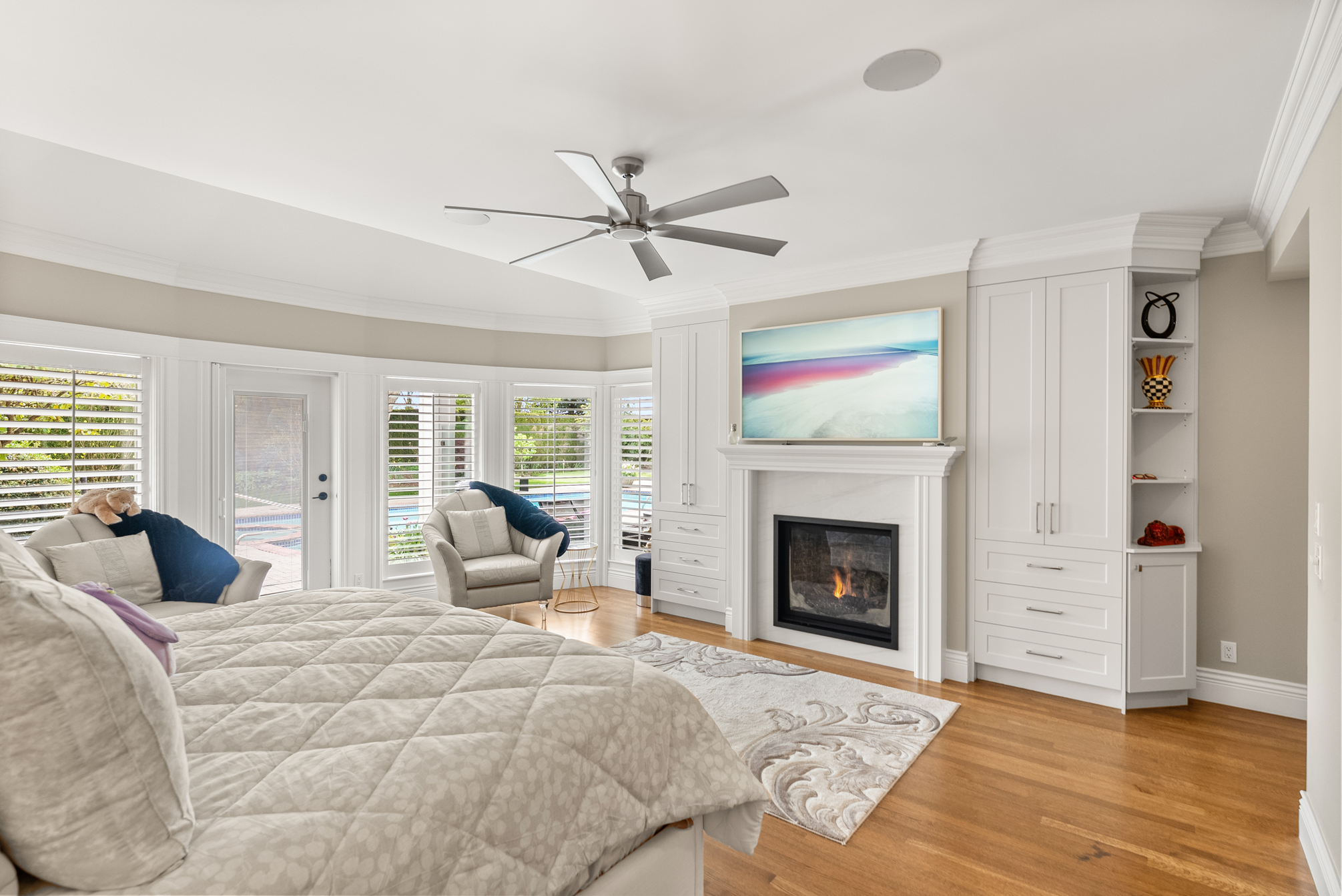 Primary bedroom with fireplace and custom built-ins